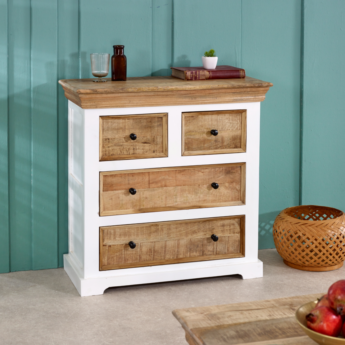 White painted wooden chest of drawers with four natural mango wood drawers and black round knobs for storage