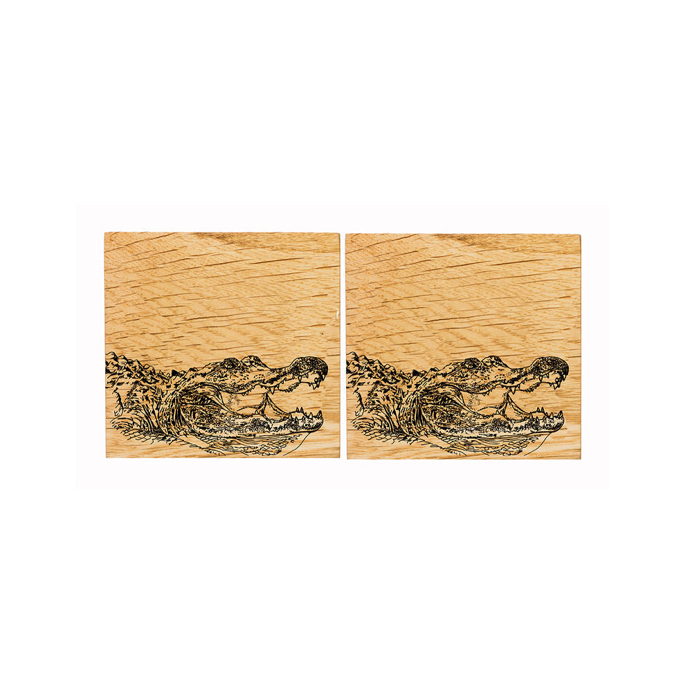 Pair of light british oak coasters with detailed engraved alligator designs perfect for drink protection