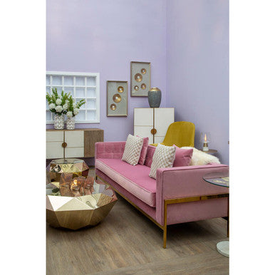 Pink velvet sofa with gold tone metal legs and champagne gold diamond cut end table with throw pillows
