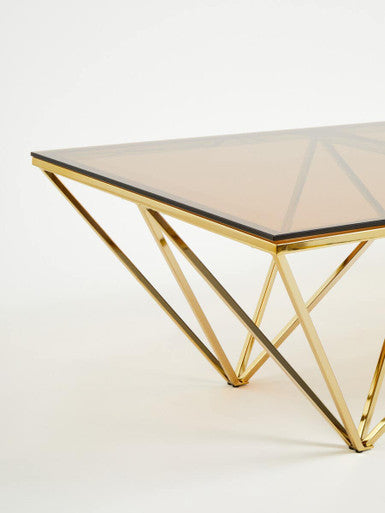 Allure champagne metal prismatic legs coffee table with gold-toned geometric metal frame and smoked glass top