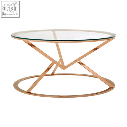 Allure corseted round rose gold coffee table with clear glass top and geometric rose gold metal legs