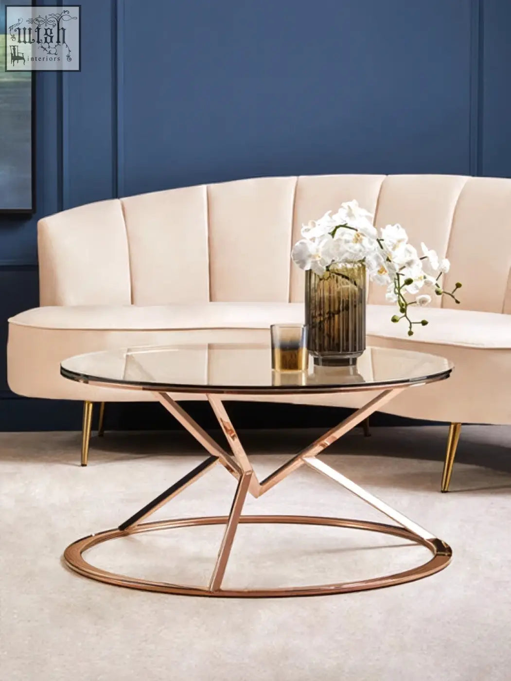Rose gold coffee table with a clear glass top and geometric circular base perfect for stylish living rooms