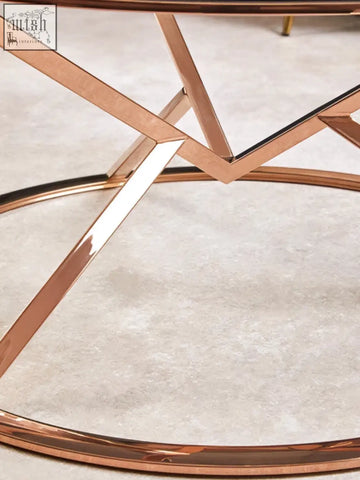 Allure corseted round rose gold coffee table with geometric metal frame and sleek rose gold finish