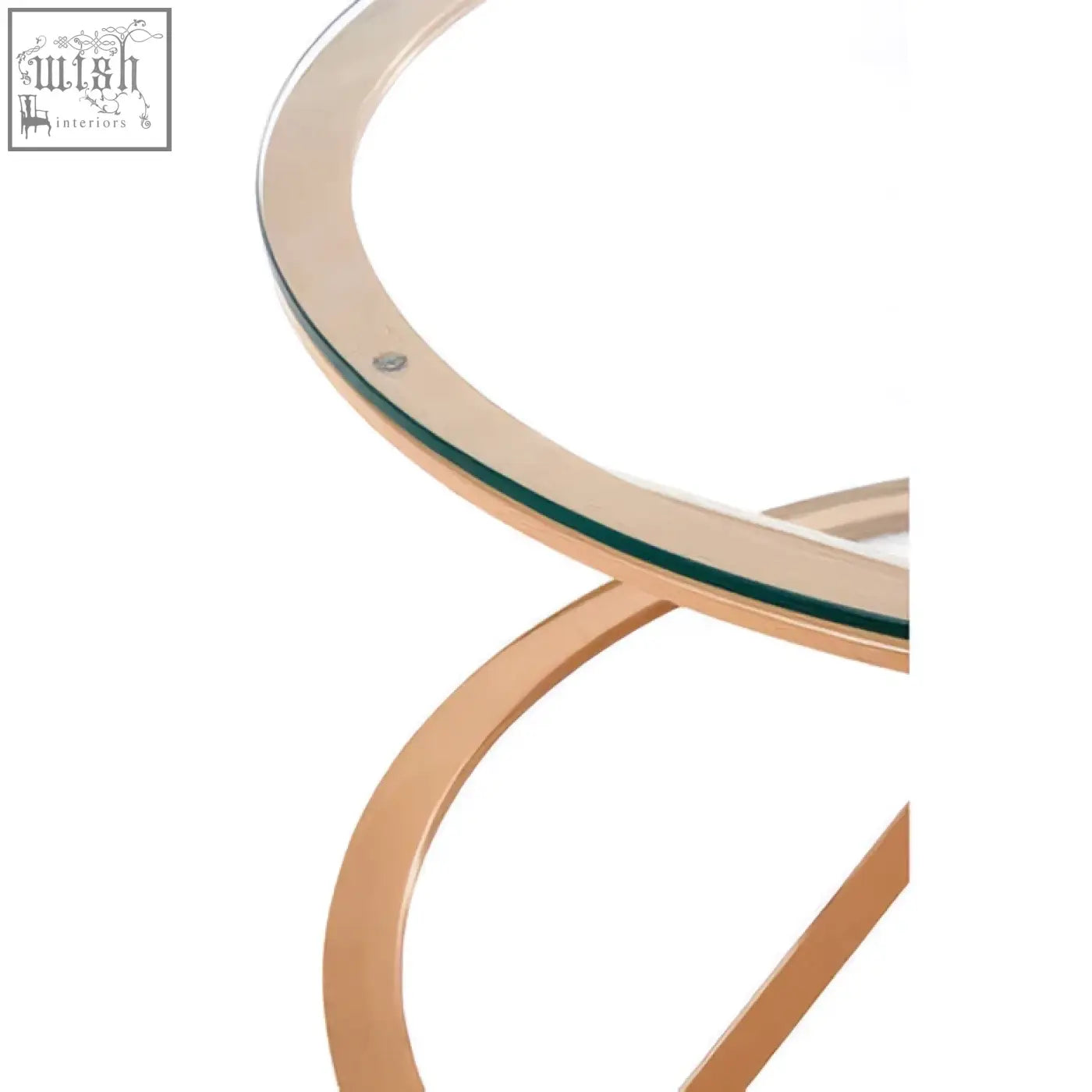A sleek rose gold coffee table with a clear glass top and curved metal legs perfect for stylish living spaces