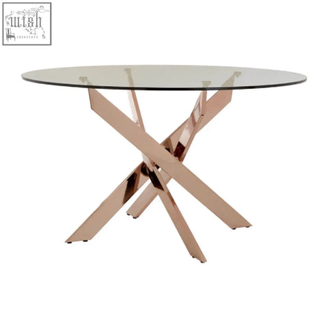 Allure round dining table with intersected rose gold metallic x-shaped base and clear glass tabletop