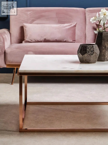 The allure square rose gold and marble coffee table features a sleek white marble top with rose gold metal legs and frame