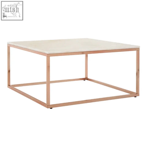 A modern square rose gold coffee table with a sleek white marble top perfect for stylish living spaces