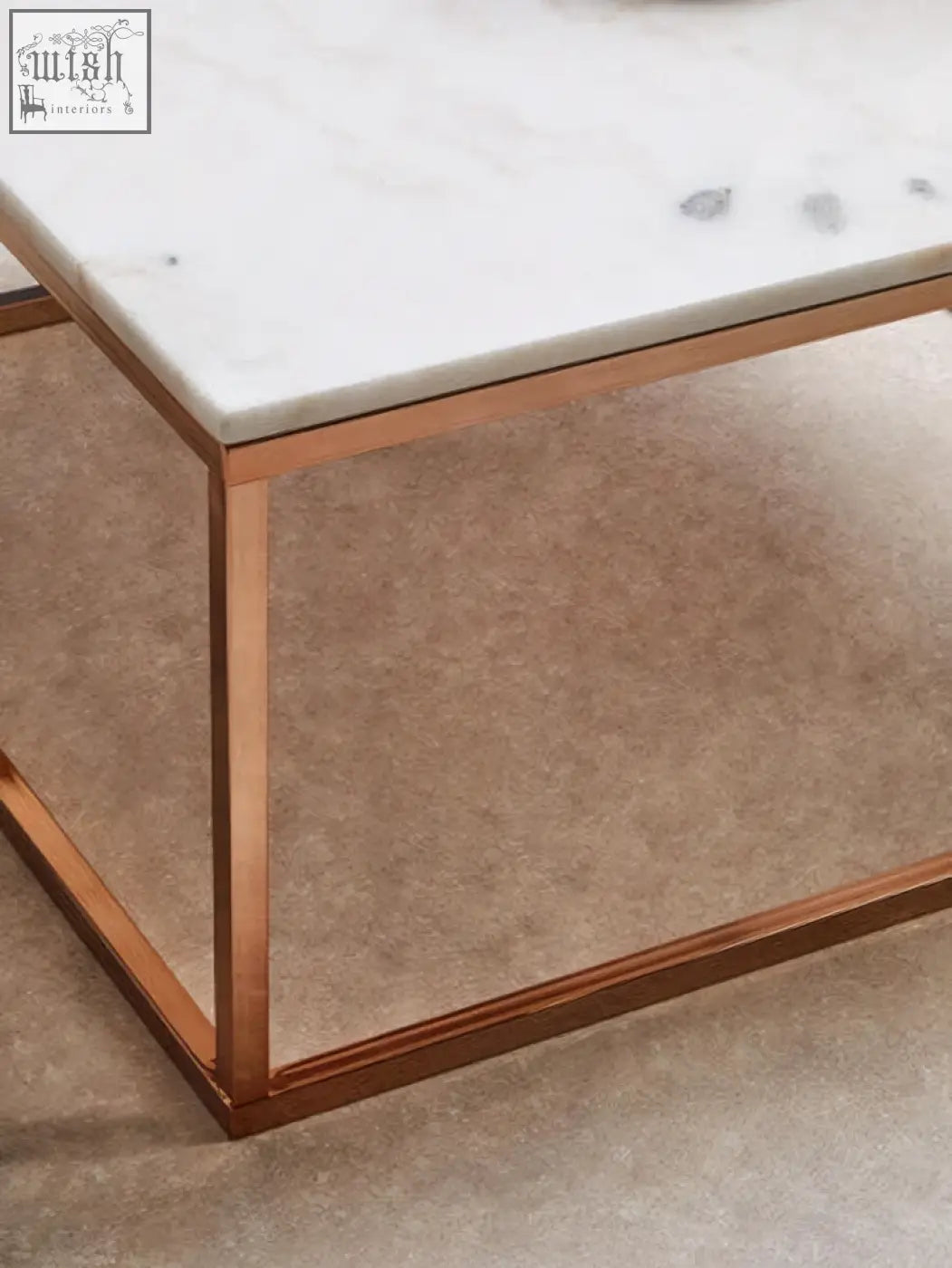 A sleek square rose gold coffee table with a white marble top and metal legs perfect for stylish living rooms