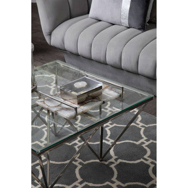 Glass-top coffee table with geometric metal frame and chrome legs featuring tempered glass for sleek style
