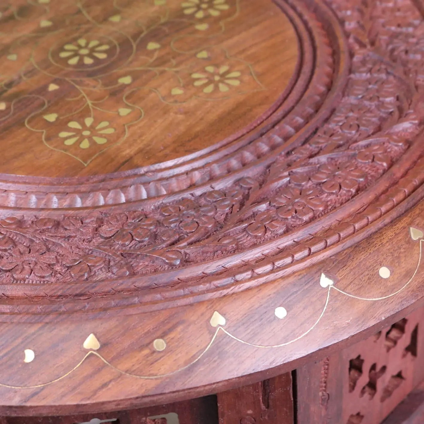 Rich mahogany alnif moroccan side table with intricate floral carvings and gold accents in sheesham wood