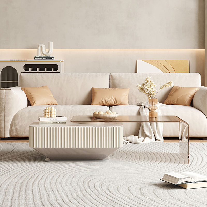 Cream-colored alonso coffee table with ribbed sintered stone base and sleek glass top for minimalist style