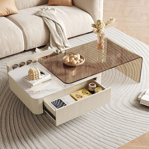 Modern cream-colored alonso coffee table with sintered stone marble top and ribbed sides with open storage drawers