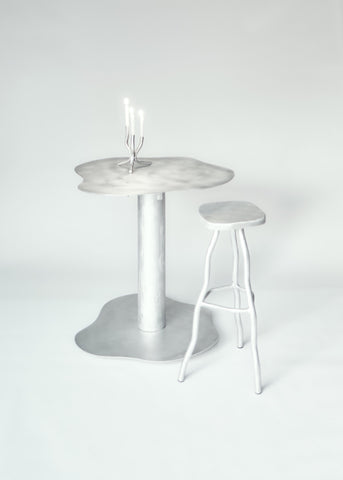 Silver metallic aluminium bar stool with a melting organic shape and matching stool for modern seating