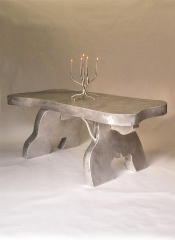 Silver forged aluminium big table with smooth textured top and organic tree-like legs for dining use