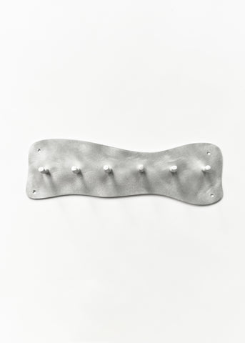 Silver metallic aluminium coat rack wall mounted with six hooks and a wavy textured surface