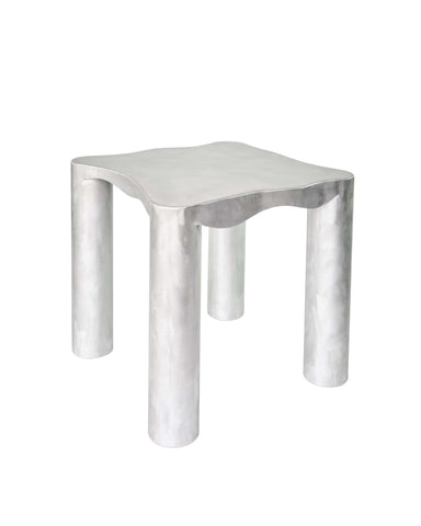 Silver metallic aluminium kitchen table with smooth wavy top and cylindrical legs for modern kitchen use