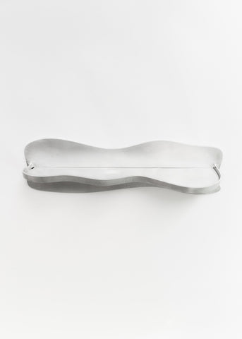A sleek silver-toned aluminium middle shelf with a smooth wave design and rounded edges for stylish storage