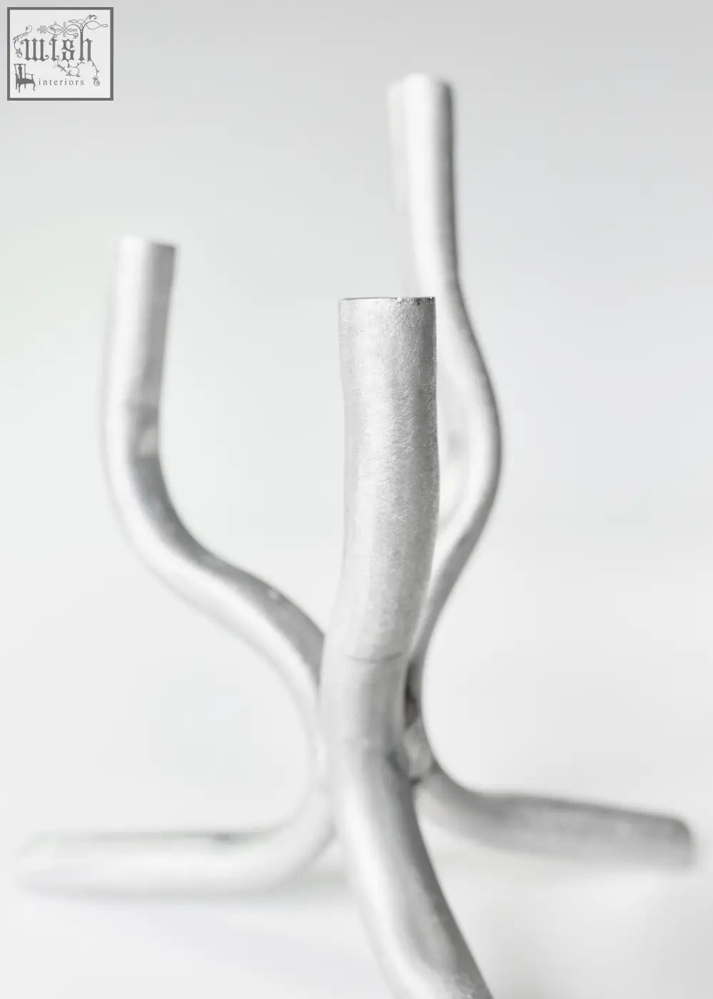 Silver metallic aluminium mini candelabra with sleek curved branches and minimalist design for elegant decor