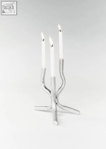 Silver metallic aluminium mini candelabra with three curved arms holding white taper candles