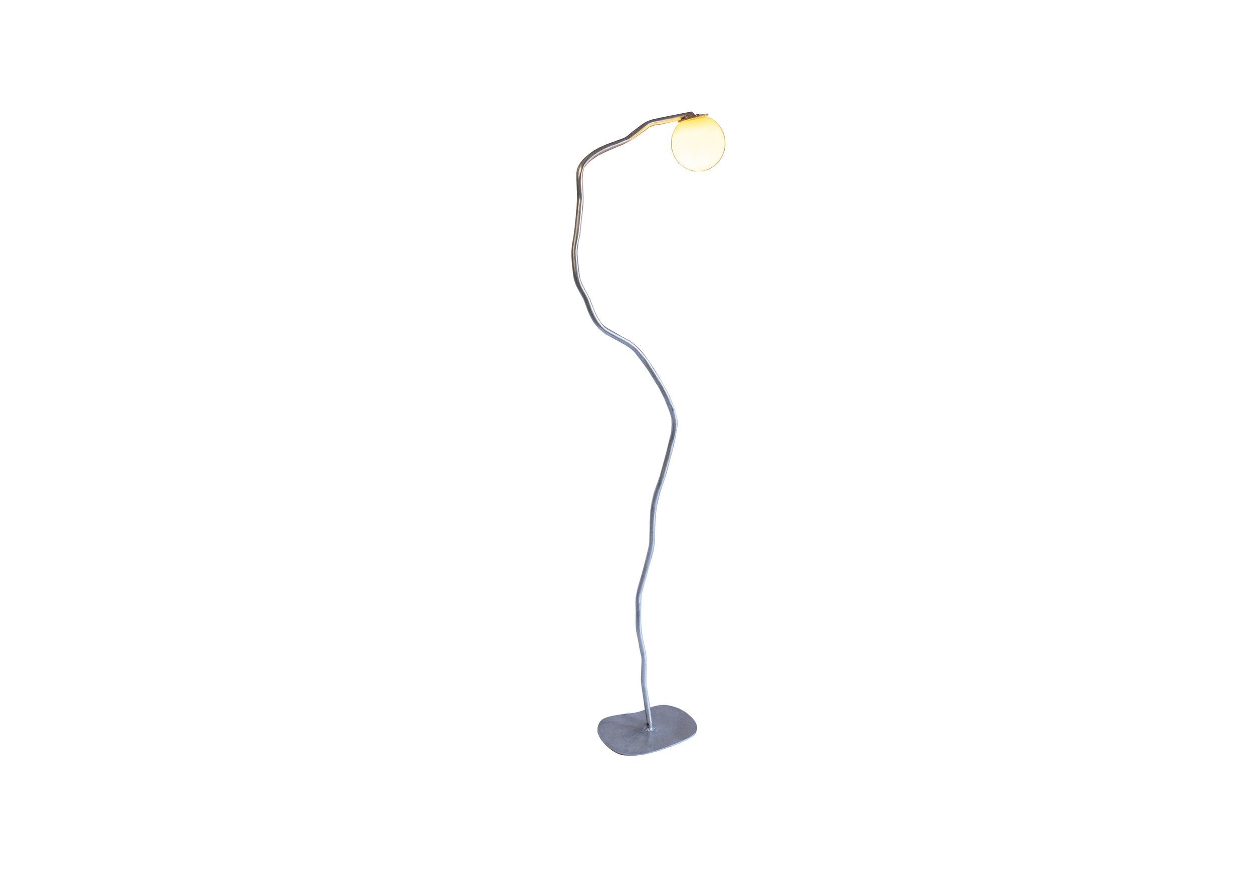 A sleek aluminium pea head lamp with a curved metallic finish and an illuminated spherical bulb