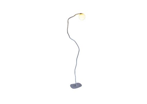 A sleek aluminium pea head lamp with a curved metallic finish and an illuminated spherical bulb