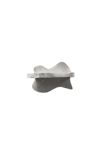 Silver metallic aluminium small shelf with smooth organic shape and two circular mounting holes visible