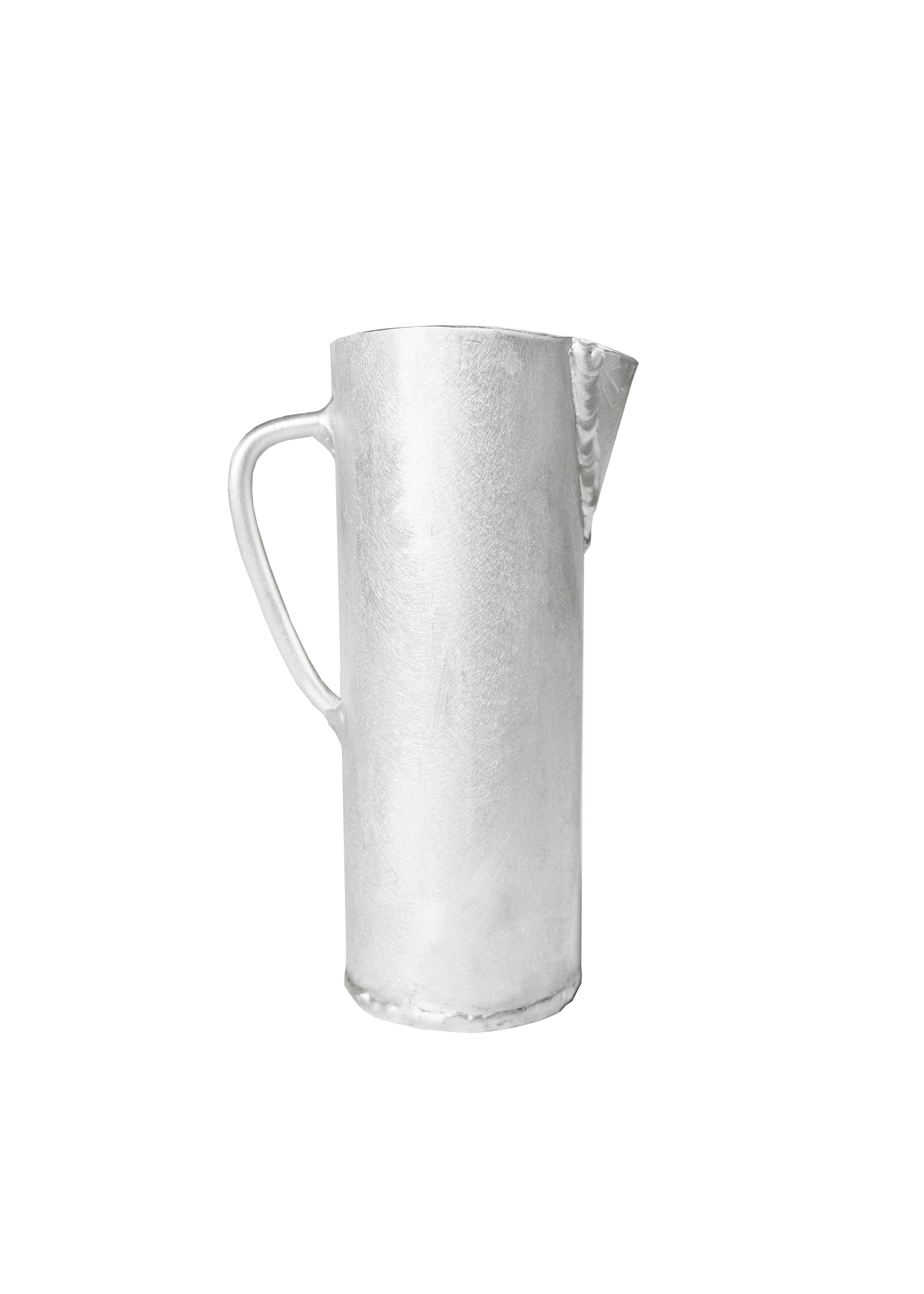 Silver hammered aluminium jug with curved handle and spout perfect for pouring liquids