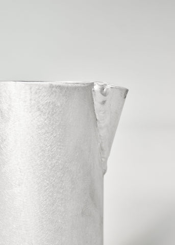 Silver-toned aluminium jug with hammered texture and flared rim perfect for serving drinks
