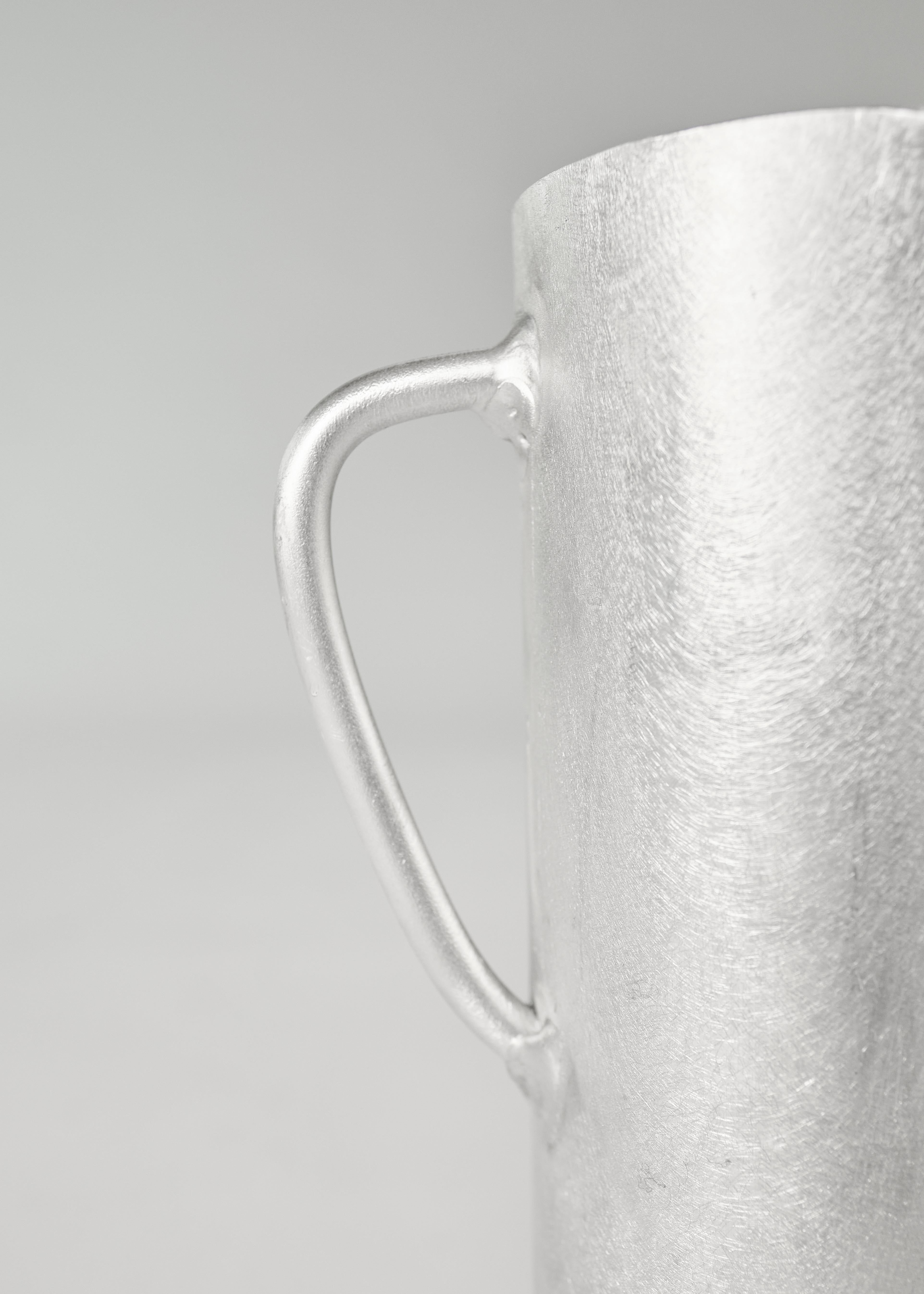 Silver-toned textured aluminium mug with sleek handle perfect for stylish everyday use