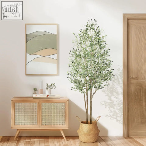 Tall faux olive tree with green leaves black olives and natural wood trunk in woven wicker pot for indoor outdoor use