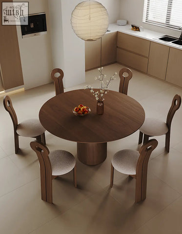Amaia round pedestal dining table in solid wood with a smooth dark brown finish and cylindrical base