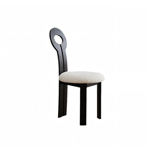 Black wooden amaris dining chair with circular backrest and cream boucle upholstered seat for dining use