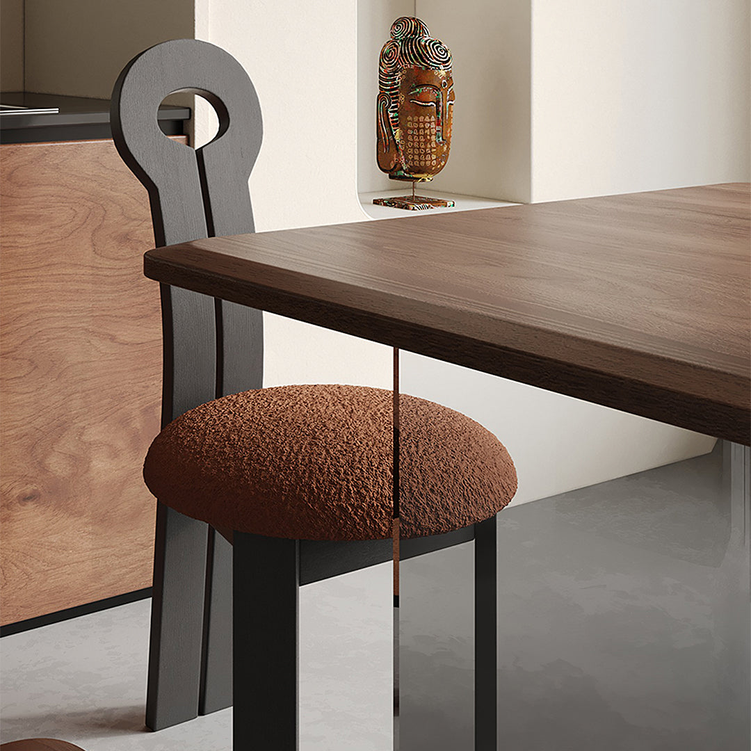 Modern black amaris dining chair with a textured brown boucle cushioned seat and keyhole backrest design