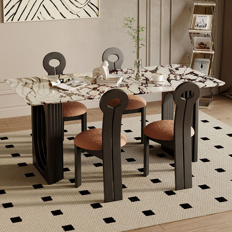 Modern amaris dining table with white and black marble top and dark metal legs with matching circular backrest chairs