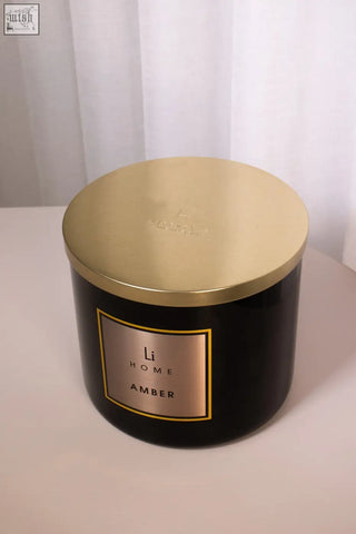 Black cylindrical large candle with gold lid and label from li home amber scent 3 wick luxury candle 1kg collection