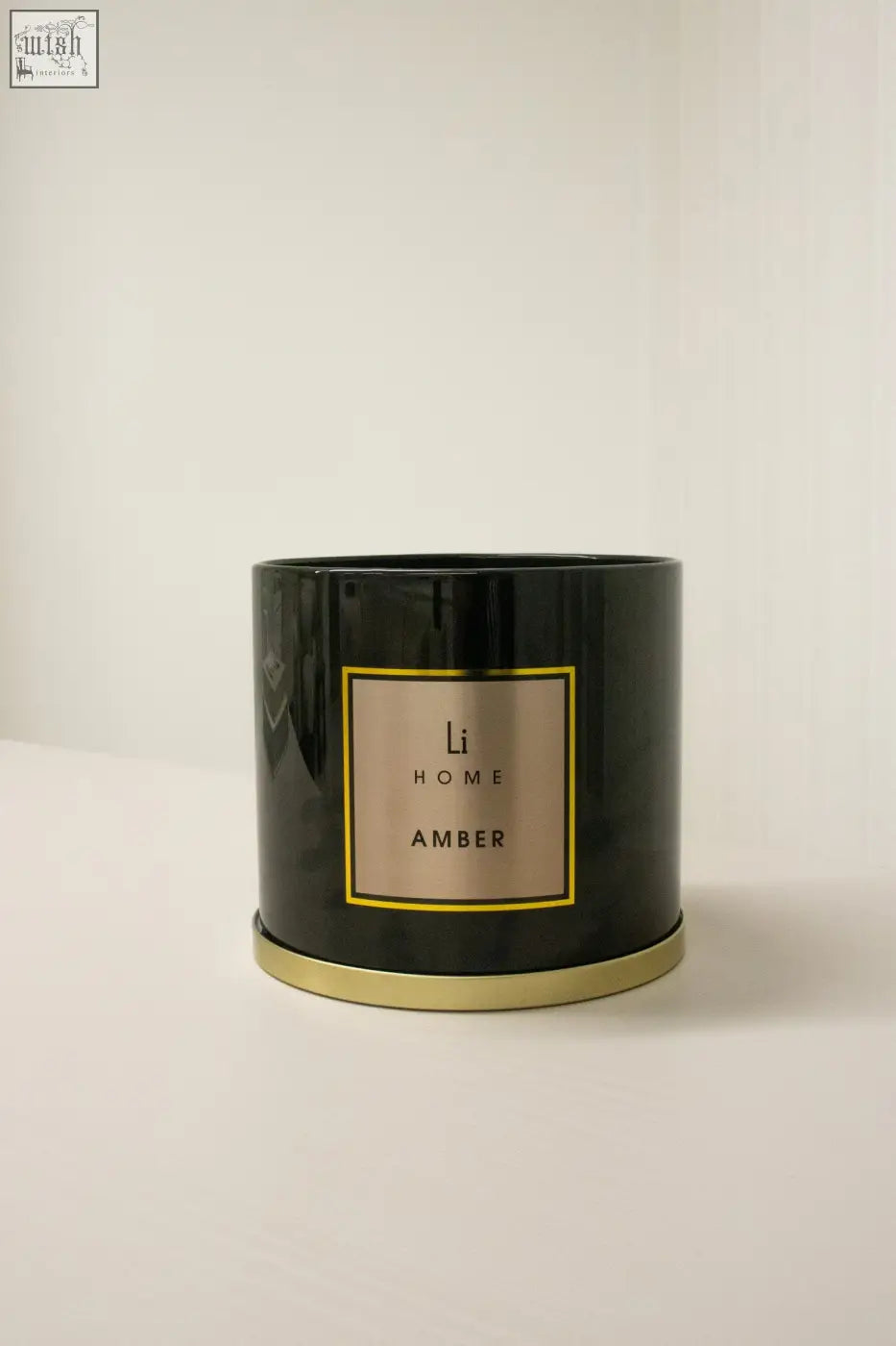 Black cylindrical amber 3 wick luxury candle 1kg with gold-rimmed label perfect for large candle collection