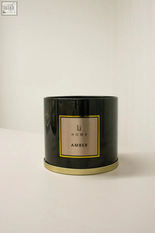 Black cylindrical amber 3 wick luxury candle 1kg with gold-rimmed label perfect for large candle collection