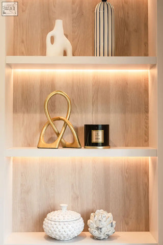 Gold abstract sculpture with intertwined loops featured in amber 3 wick luxury candle for large candle collection