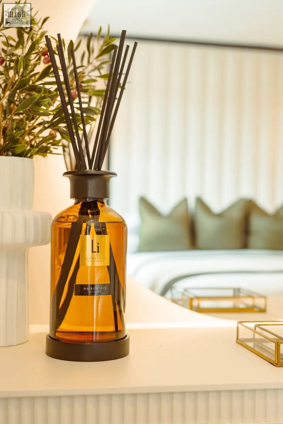 Amber glass reed diffuser with black reeds and sleek modern design from the lifestyle home collection premium xxl refill