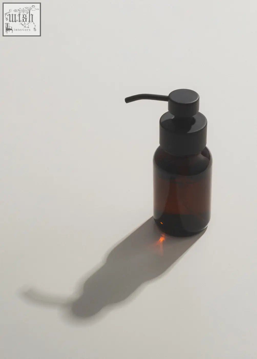 A sleek dark amber foaming hand soap dispenser with a matte black stainless steel pump for easy use