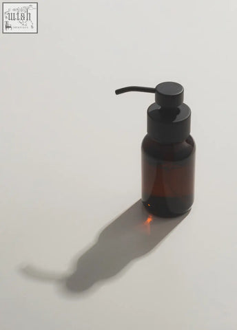 A sleek dark amber foaming hand soap dispenser with a matte black stainless steel pump for easy use