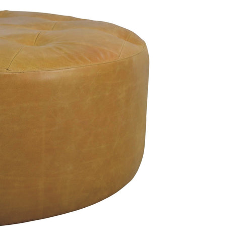 Tan leather ottoman with tufted top and rounded edges perfect as an amber oak coffee table accent piece