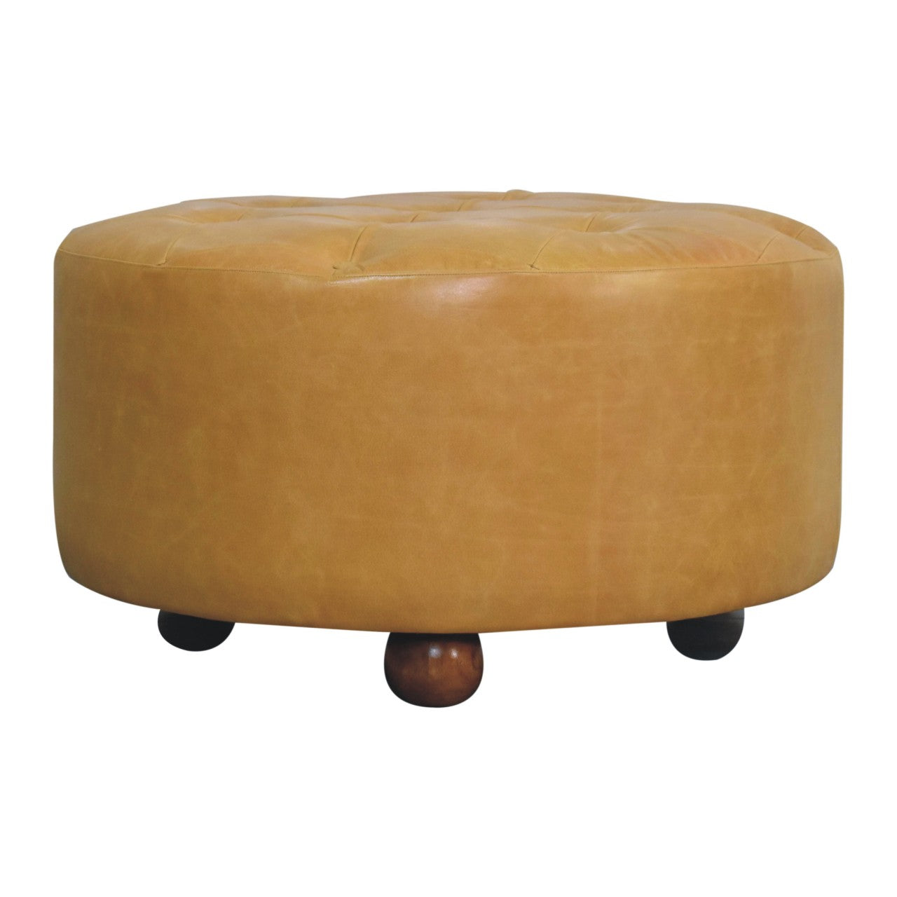 Tan leather tufted ottoman with rounded wooden legs serving as an amber oak leather coffee table centerpiece