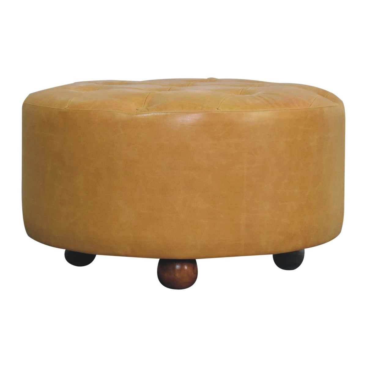 Tan leather tufted ottoman with rounded wooden legs serving as an amber oak leather coffee table centerpiece