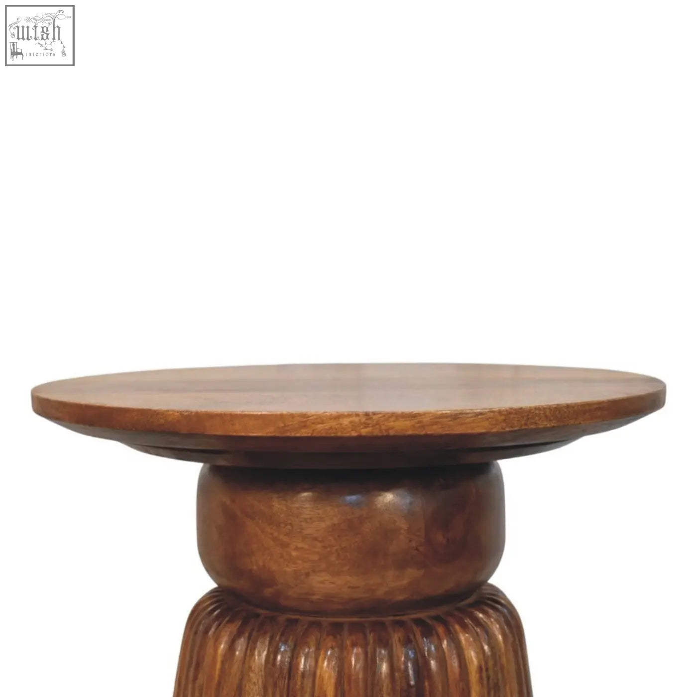 A round amber oak side table with a smooth top and intricately carved fluted wooden base in medium brown