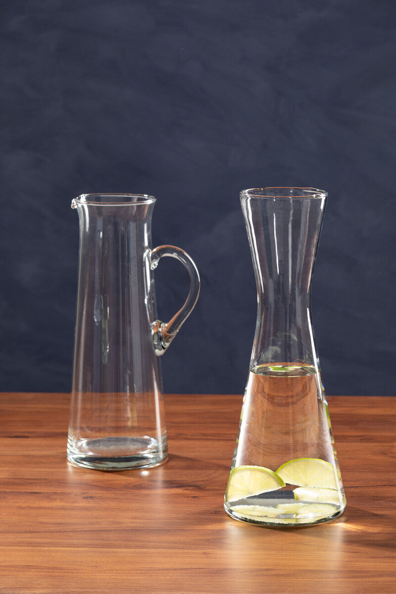 Ambra clear glass carafe with curved handle and tapered neck filled with liquid and lime slices