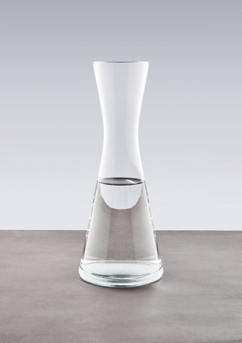 Ambra clear glass carafe with a sleek modern design featuring a wide base tapering to a narrow neck glass carafe