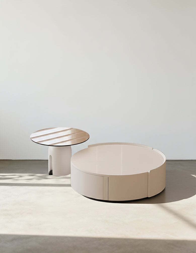 Cream-colored circular amelia coffee table set with sleek minimalist design and subtle vertical grooves on side
