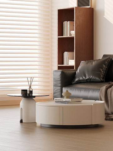 Cream-colored oval coffee table with sleek modern design and vertical grooves in the amelia coffee table set