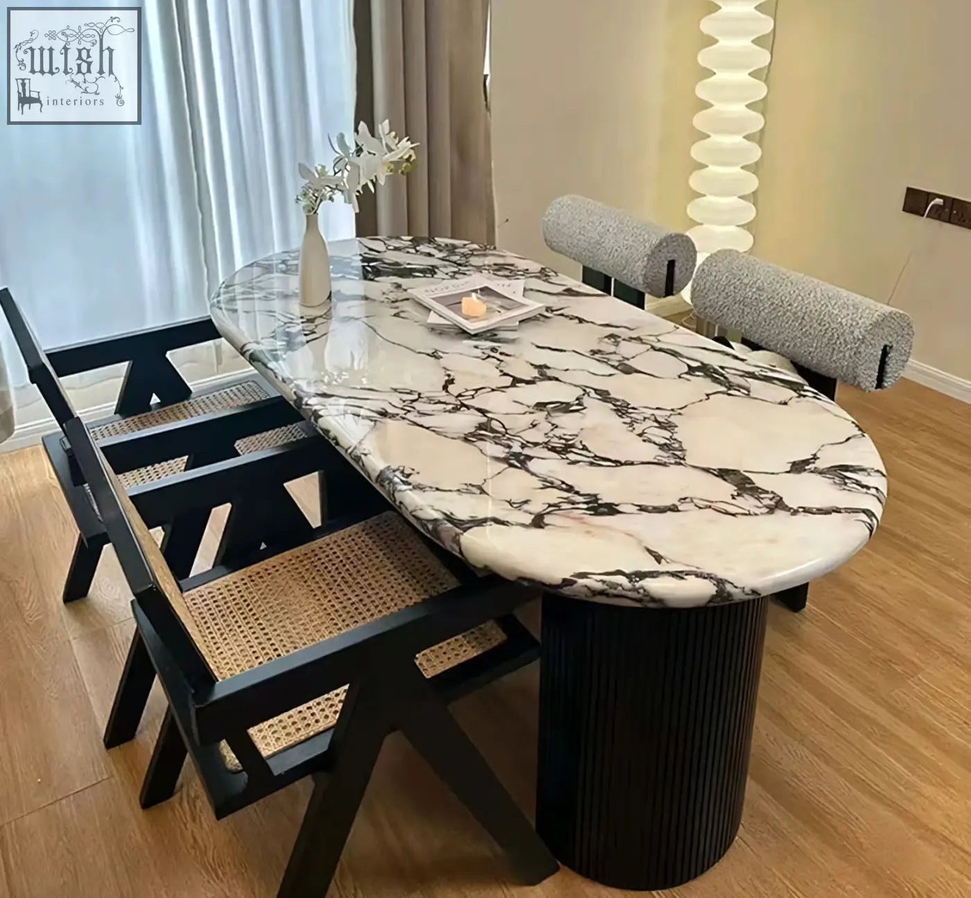 Elegant amina oval dining table with white and black marble top and black ribbed pedestal base for dining room